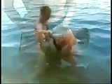 Young couple have sex in a lake
